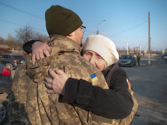 Elderly mother says goodbye to her military son.